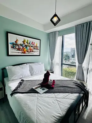 a bedroom with a large bed with a window at Enter Home McKinley with a View in Manila