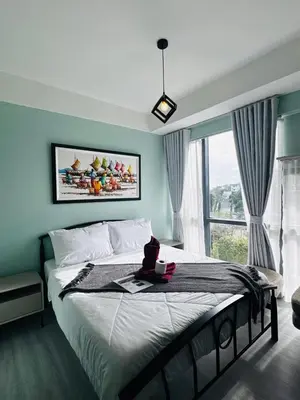 a bedroom with a large bed and a large window at Enter Home McKinley with a View in Manila