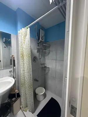 a bathroom with a shower and a toilet and a sink at Sea Residences Tower A 7th floor facing pool by Richnells your cozy oasis in Manila