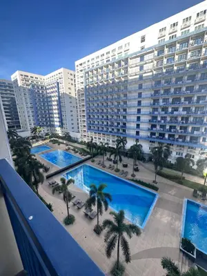 a view of a large apartment building with two pools at Sea Residences Tower A 7th floor facing pool by Richnells your cozy oasis in Manila