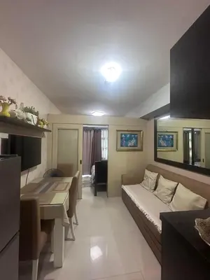 a small room with a bed and a desk in it at Sea Residences Tower A 7th floor facing pool by Richnells your cozy oasis in Manila