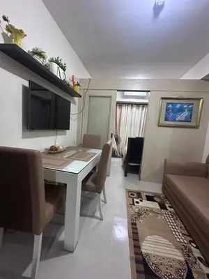 a living room with a table and a couch at Sea Residences Tower A 7th floor facing pool by Richnells your cozy oasis in Manila
