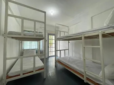 a room with three bunk beds and a window at Lawton Residences Studio Room 2I - 4 pax in Manila
