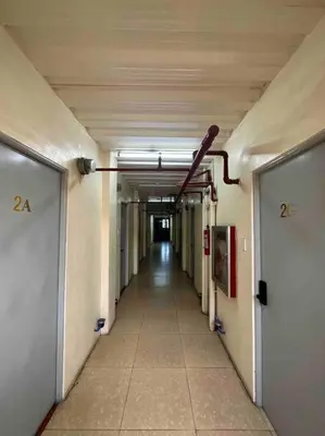 an empty hallway in a building with a long corridor at Lawton Residences Studio Room 2J - 4 pax in Manila