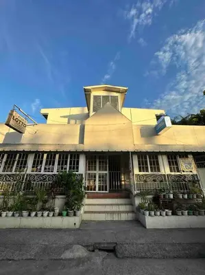 a large yellow building with a clock on top of it at Lawton Residences Studio Room 3B - 4 pax in Manila