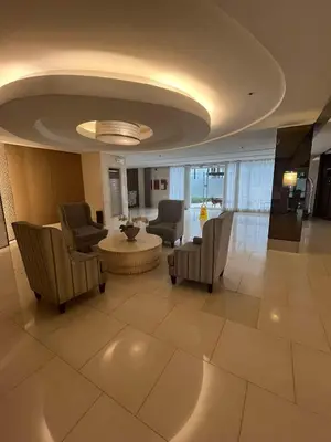 a lobby with chairs and a table in a building at Adrianne Condotel at Shell Residences Condominium, MOA Complex, Pasay City in Manila