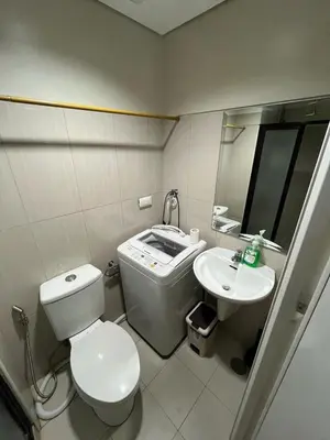 a small bathroom with a toilet and a sink at Adrianne Condotel at Shell Residences Condominium, MOA Complex, Pasay City in Manila