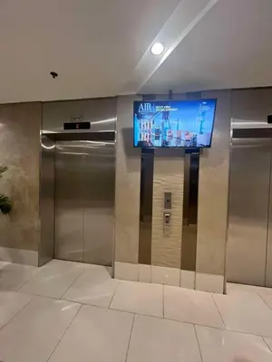 an elevator in a building with a television on the wall at Adrianne Condotel at Shell Residences Condominium, MOA Complex, Pasay City in Manila
