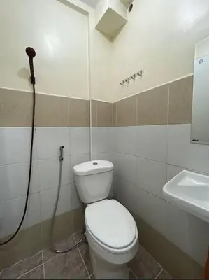 a bathroom with a toilet and a sink at Lawton Residences Studio Room 3D - 4 pax in Manila