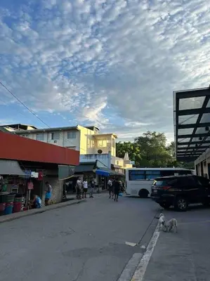 a group of people and a bus on a street at Lawton Residences Studio Room 3D - 4 pax in Manila