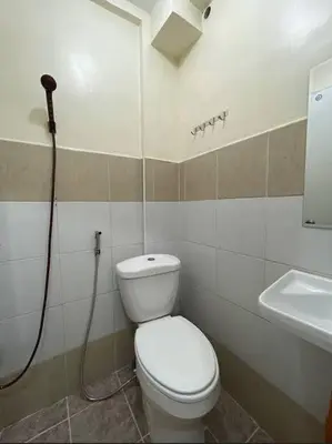 a bathroom with a toilet and a sink at Lawton Residences Studio Room 3E in Manila