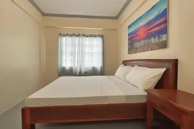 a bedroom with a large bed with a window at Lawton Residences Studio Room 3K in Manila
