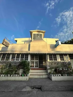 a large white building with a clock on top of it at Lawton Residences Studio Room 2B in Manila