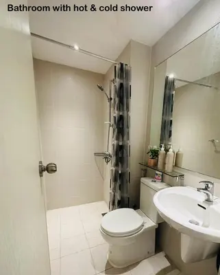 a bathroom with a toilet and a sink and a shower at Azure Urban Resort Residences in Manila