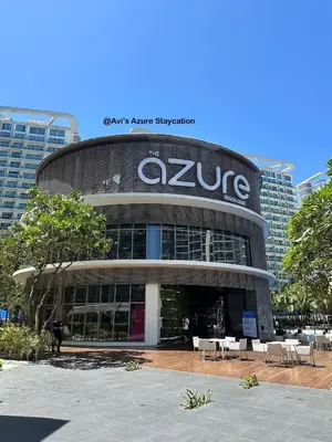 a large building with a sign on top of it at Azure Urban Resort Residences in Manila