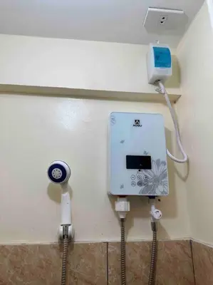 a room with a wall with a electrical outlet and a charger at Lawton Residences Studio Room 2D in Manila