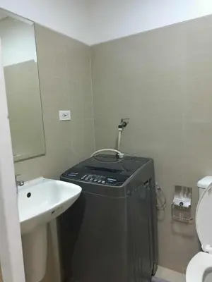 a small bathroom with a sink and a toilet at Shore Residences - 1 Bedroom Condo Unit in Manila