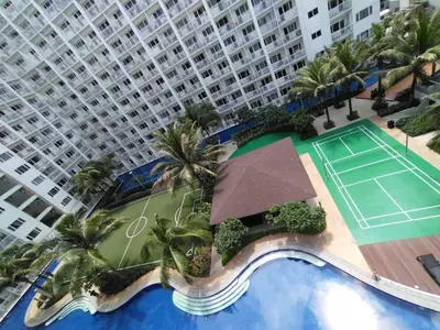 an aerial view of a tennis court in front of a large building at Shore Residences - 1 Bedroom Condo Unit in Manila