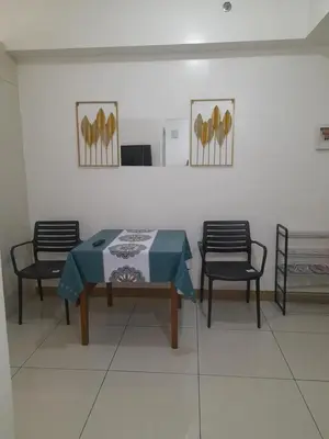 a dining room with a table and two chairs at SMDC 2Bedroom SM Southmall in Manila