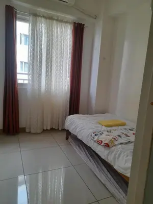 a small bedroom with a bed and a window at SMDC 2Bedroom SM Southmall in Manila