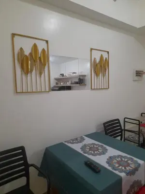a room with a table and chairs and a kitchen at SMDC 2Bedroom SM Southmall in Manila