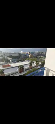 a view of a city from inside a building at Derick Staycation With Balcony Moa View in Manila