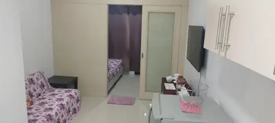a living room with a couch and a mirror at Derick Staycation With Balcony Moa View in Manila