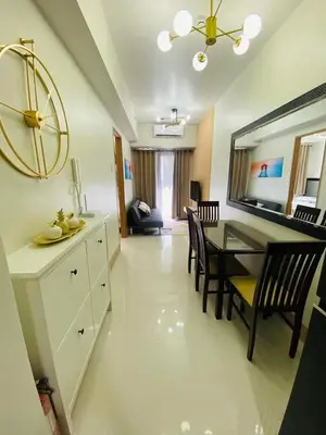 a kitchen and dining room with a table and chairs at Sofias Haven - Shore 3 Residences T1 in Manila