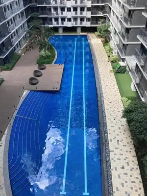 an empty swimming pool in the middle of a building at Sofias Haven - Shore 3 Residences T1 in Manila