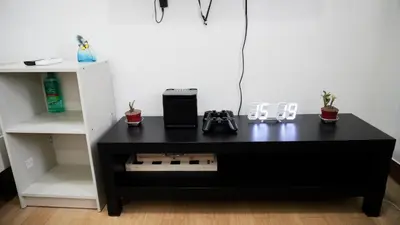 a black desk in a room with a white shelf at Warm & Cozy Retreat near SM City Trece Martires in Trece Martires