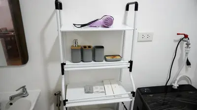 a shelf in a bathroom with a sink at Warm & Cozy Retreat near SM City Trece Martires in Trece Martires