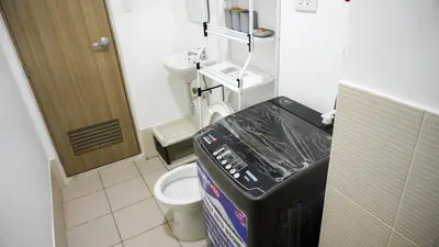 a small bathroom with a toilet in a room at Warm & Cozy Retreat near SM City Trece Martires in Trece Martires