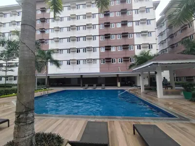 a swimming pool in front of a hotel at Warm & Cozy Retreat near SM City Trece Martires in Trece Martires