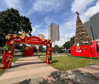 a christmas tree in the middle of a park at SMDC FAME apartment in Ortigas in Manila