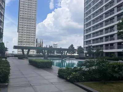 a bench in the middle of a city with buildings at Heart of Ortigas Center in Manila