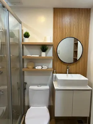 a bathroom with a toilet and a sink and a mirror at A Scandinavian-inspired studio in Silang in Bayabasan