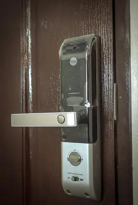 a cell phone is attached to a wooden door at A Scandinavian-inspired studio in Silang in Bayabasan