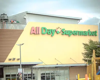 an all day supermarket sign on the side of a building at A Scandinavian-inspired studio in Silang in Bayabasan
