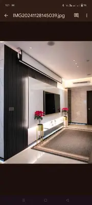 a room with a flat screen tv and red flowers at One Winstar Realty Corp in Manila