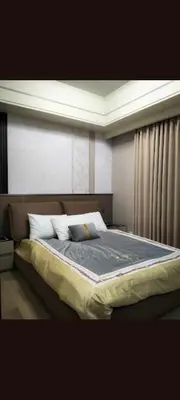 a bedroom with a large bed with two pillows at One Winstar Realty Corp in Manila