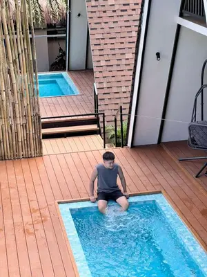 a young boy sitting in a swimming pool at Villa Teodora in Biñan