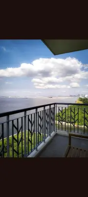 a view of the ocean from the balcony of a house at One Winstar Realty Corp in Manila