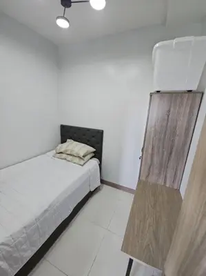 a white room with a bed and a curtain at Condo next door in Manila