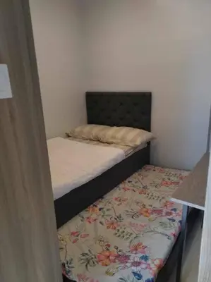 a small bedroom with two beds and a mattress at Condo next door in Manila