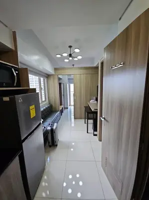 a room with a hallway with a door and a kitchen at Condo next door in Manila