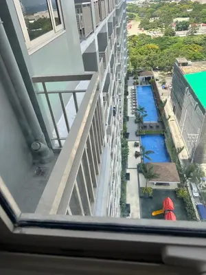 a view from a window of a building with a pool at Condo next door in Manila
