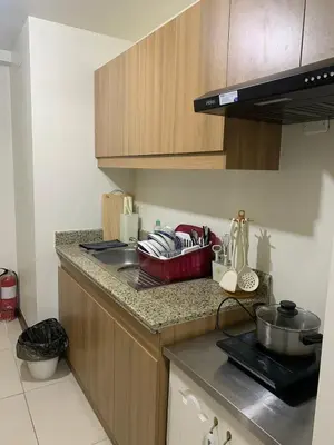 a kitchen with a sink and a counter top at Fairlane Residences in Manila