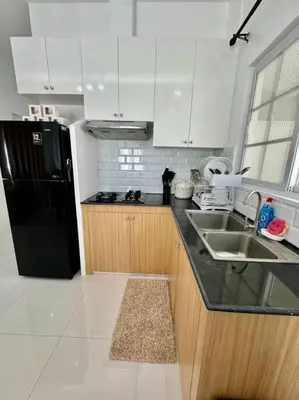 a kitchen with a black refrigerator and a sink at Casa Leonardo-Bel Air 4 in Santa Rosa