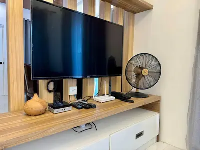 a television on a wooden shelf with a fan at Casa Leonardo-Bel Air 4 in Santa Rosa