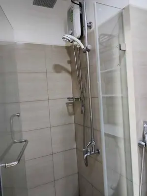 a shower with a glass door in a bathroom at Near MOA at SHORE RESIDENCES 1BR with balcony -unlimited WIFI in Manila